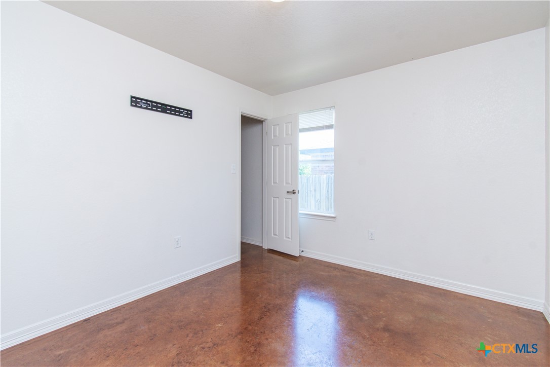 3104 Baldwin Loop, Unit B Killeen, TX 76549 - Photo 12 of 19 an empty room with wooden floor and windows