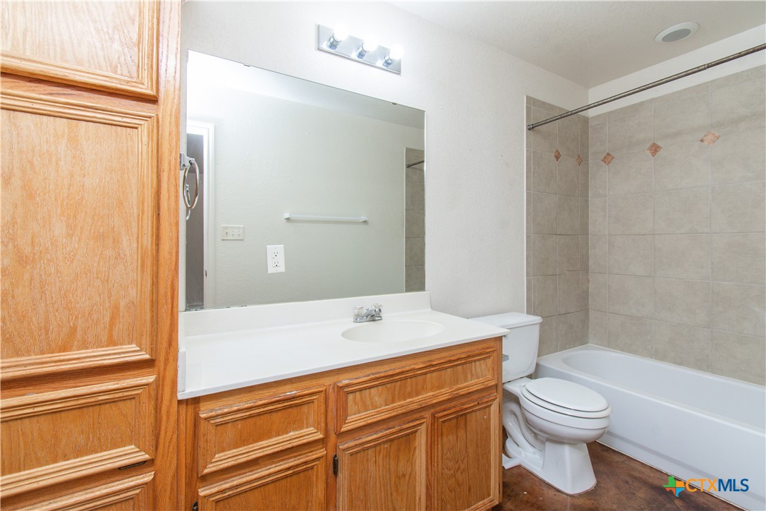 3104 Baldwin Loop, Unit B Killeen, TX 76549 - Photo 18 of 19 a bathroom with a sink a toilet and shower