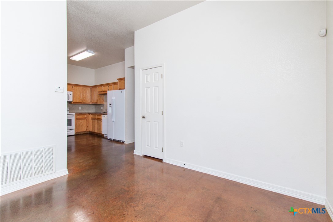 3104 Baldwin Loop, Unit B Killeen, TX 76549 - Photo 5 of 19 a view of a kitchen with a refrigerator and a window