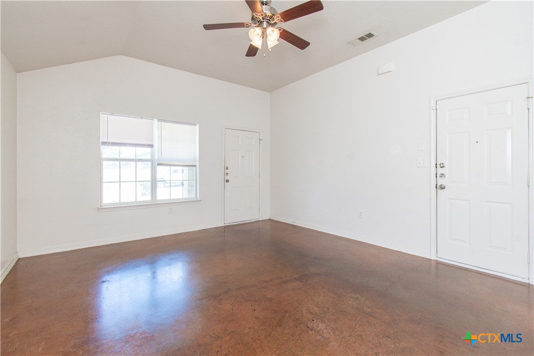 3104 Baldwin Loop, Unit B Killeen, TX 76549 - Photo 6 of 19 an empty room with windows and fan