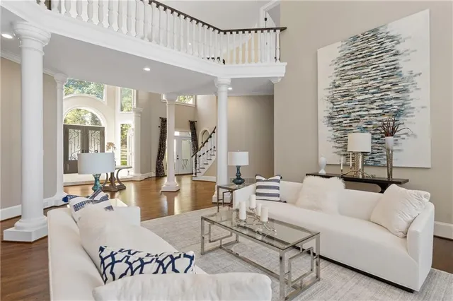 a living room with fireplace furniture and a large window