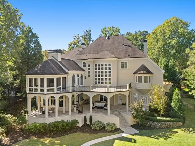 an aerial view of a house with swimming pool and garden