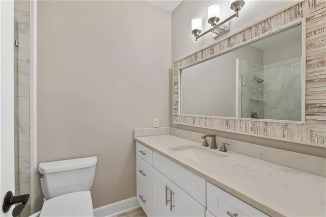 a room with wooden floor pool table and chairs
