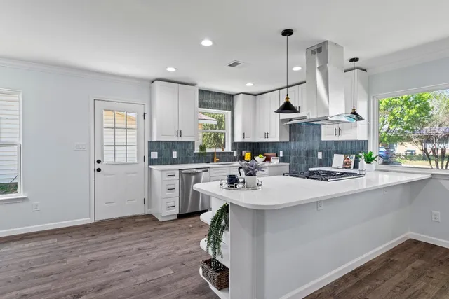a kitchen with white cabinets and white appliances