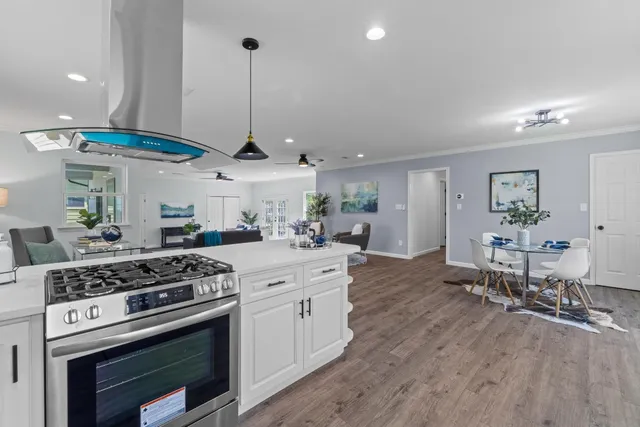 a front view of house with yard and trees in the background