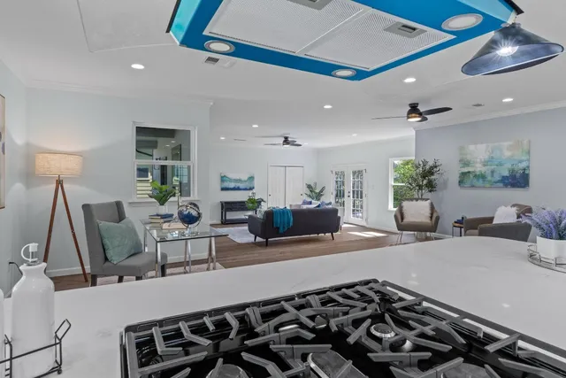 a kitchen with a stove cabinets and wooden floor