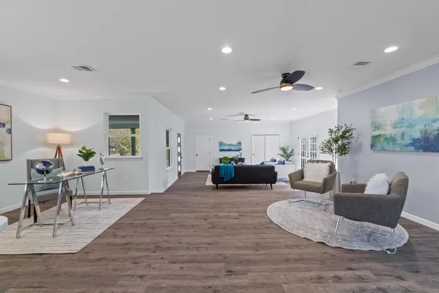 a living room with furniture kitchen view and a table