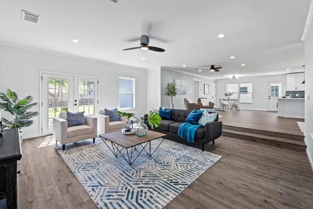 a living room with furniture and wooden floor