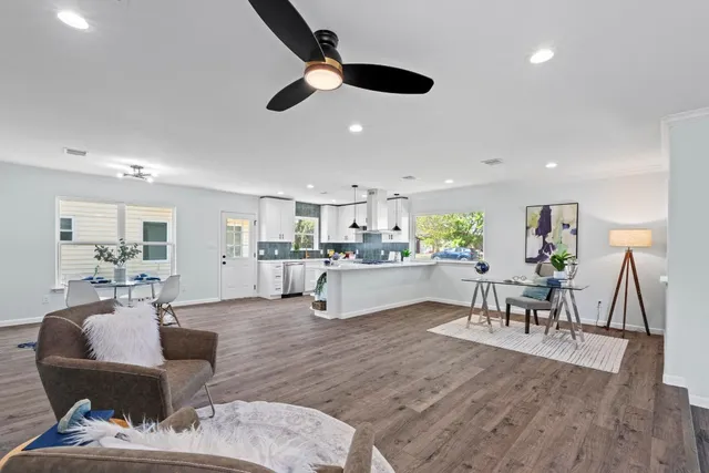 a living room with furniture and kitchen view
