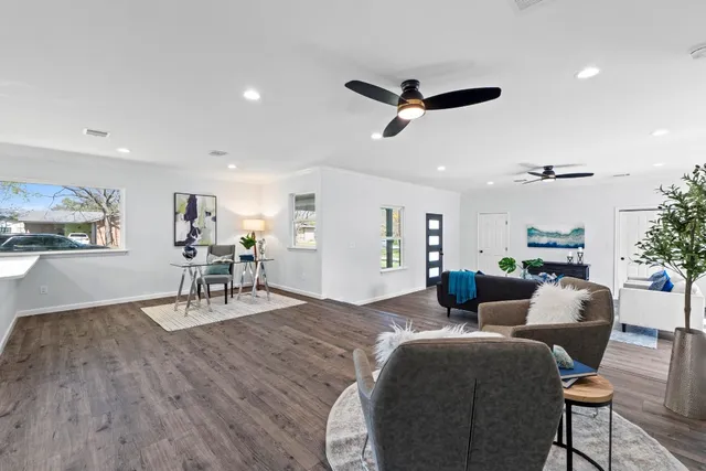 a living room with furniture and a wooden floor