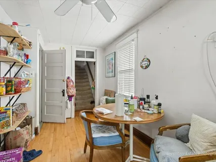 a view of a dining room with furniture and wooden floor