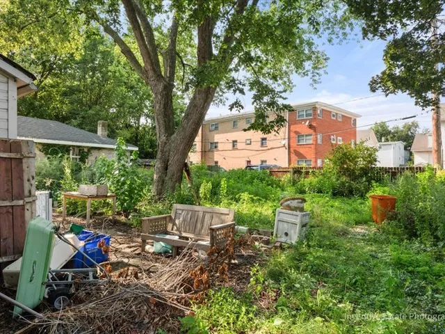 a view of a chair and table in backyard