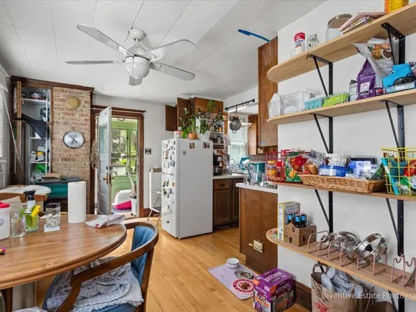 a view of a workspace with furniture and a kitchen
