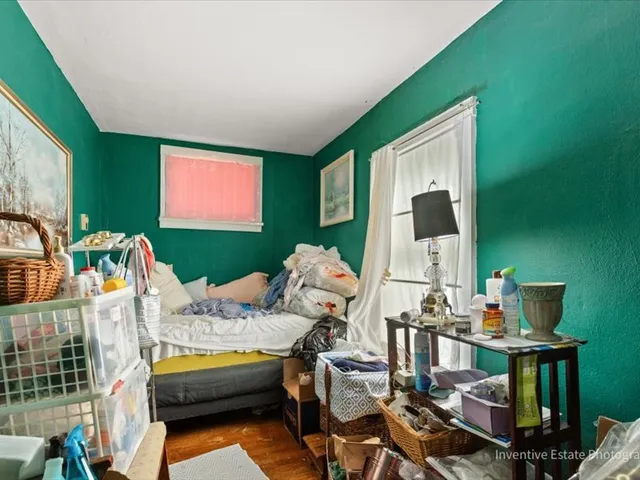a bedroom with furniture and a flat screen tv