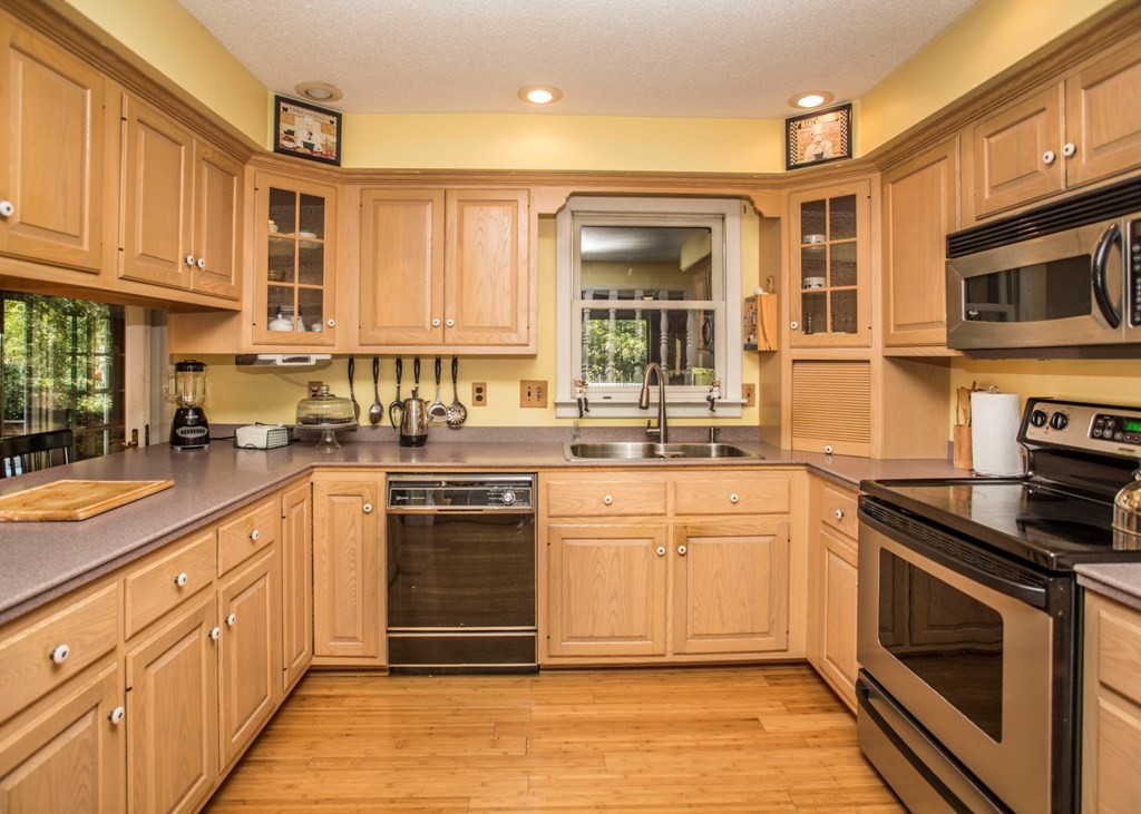 138 Sarah Sherman Road Rochester, MA 02770 - Photo 11 of 30 a kitchen with stainless steel appliances granite countertop a stove sink and cabinets