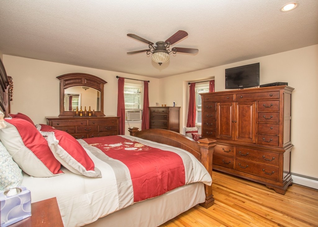 138 Sarah Sherman Road Rochester, MA 02770 - Photo 20 of 30 a bedroom with a bed and wooden floor