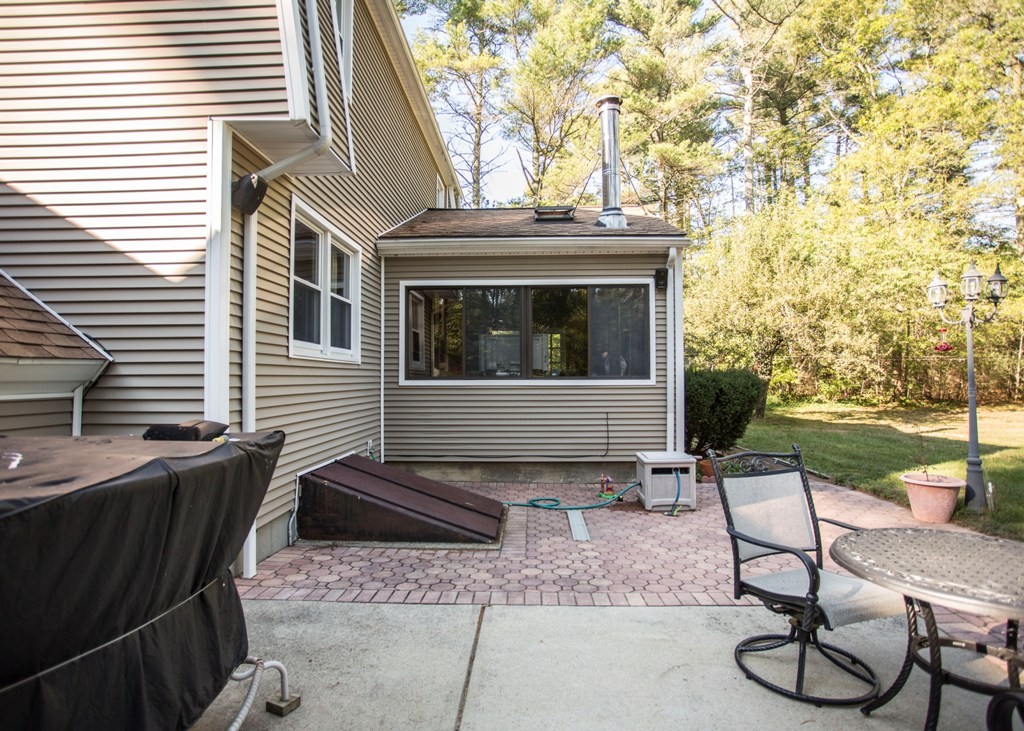 138 Sarah Sherman Road Rochester, MA 02770 - Photo 8 of 30 a view of a chairs and table in the back yard of the house