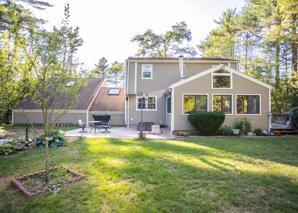 138 Sarah Sherman Road Rochester, MA 02770 - Photo 9 of 30 a front view of a house with a yard table and chairs