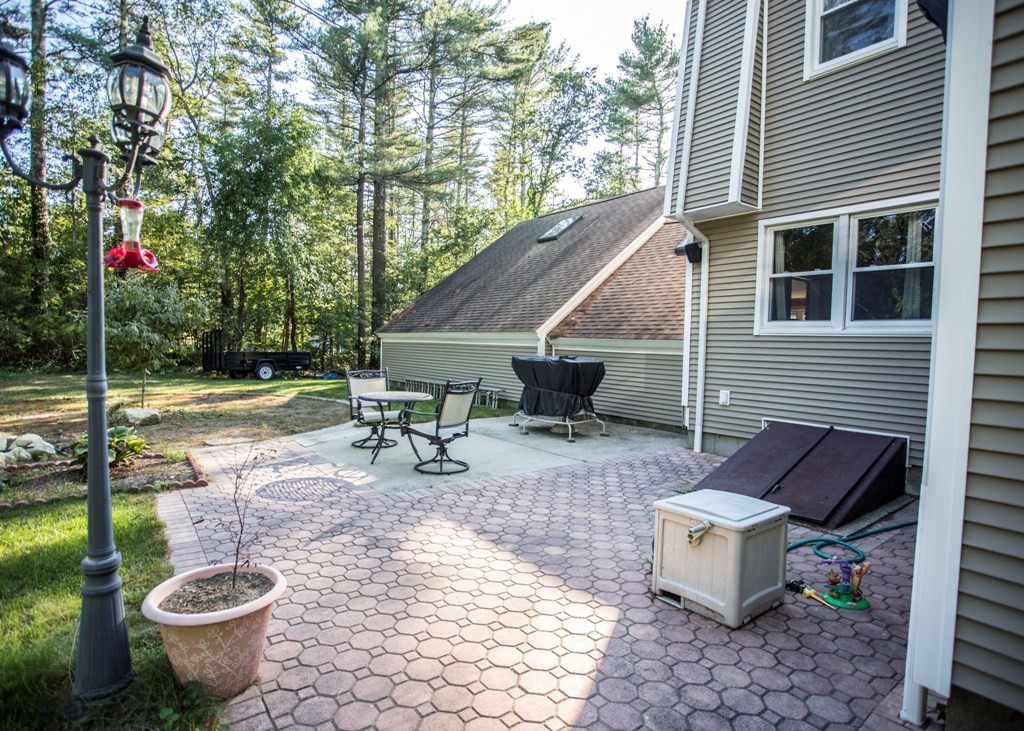 138 Sarah Sherman Road Rochester, MA 02770 - Photo 10 of 30 a view of a patio with table and chairs and potted plants