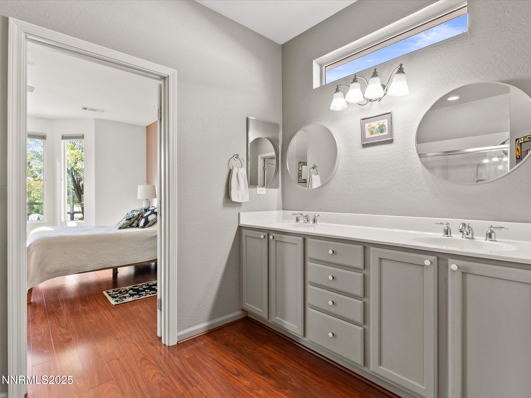 9052 Cabin Creek Trail Reno, NV 89523 - Photo 16 of 34 a bathroom with a double vanity sink and a mirror