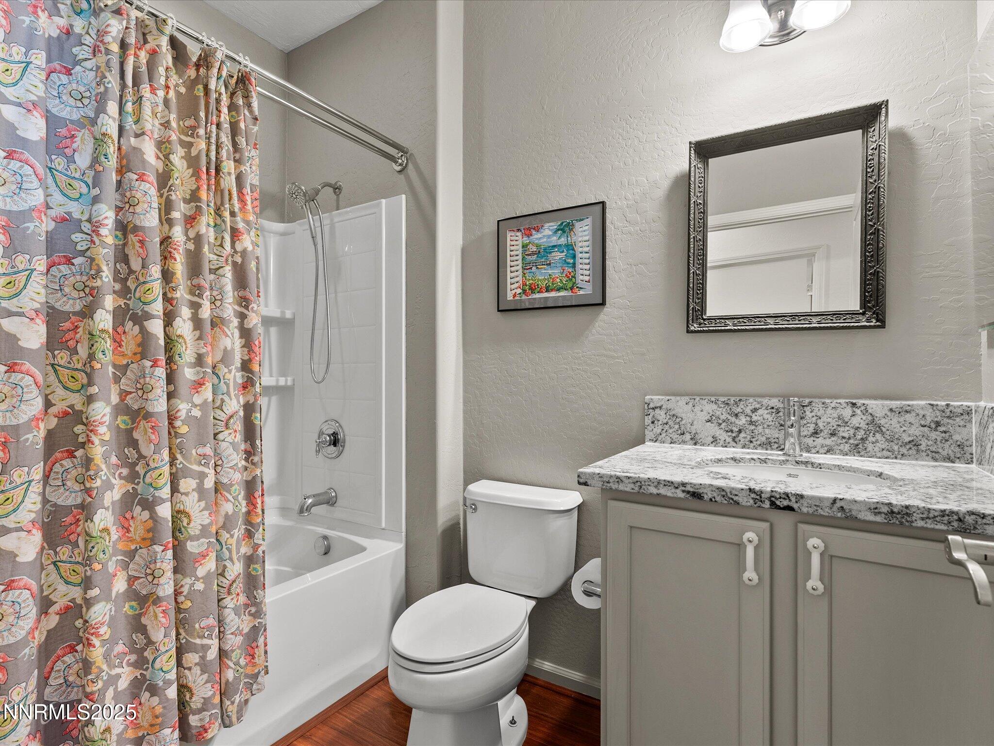 9052 Cabin Creek Trail Reno, NV 89523 - Photo 21 of 34 a bathroom with a granite countertop sink toilet and shower