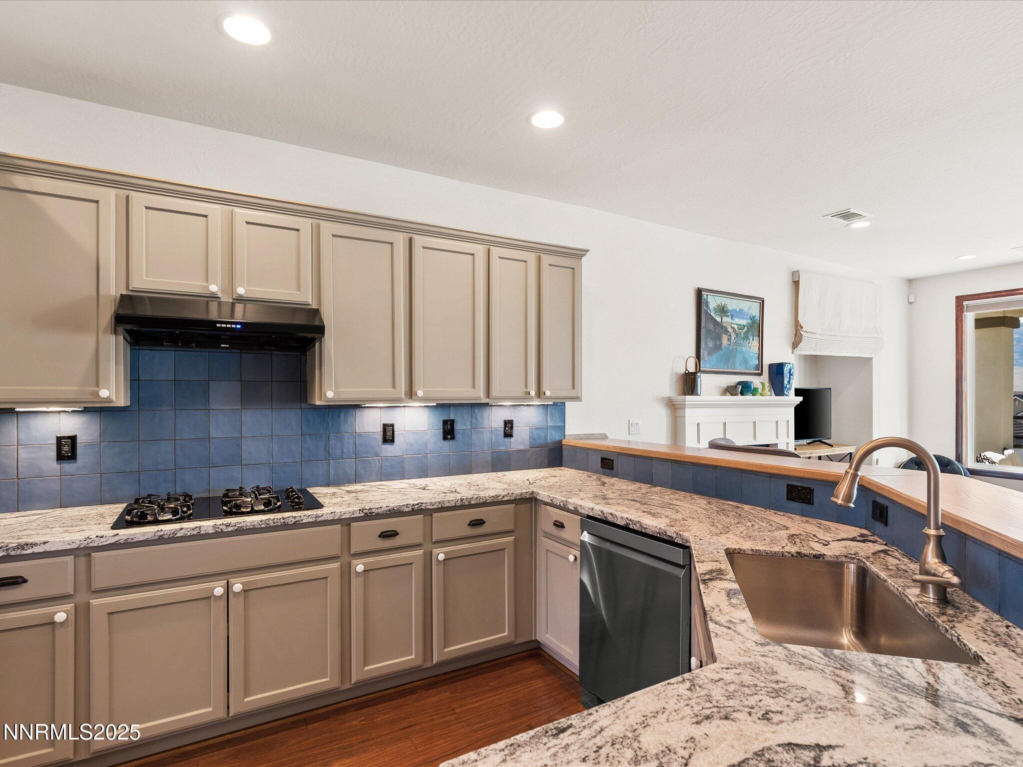 9052 Cabin Creek Trail Reno, NV 89523 - Photo 9 of 34 a kitchen with granite countertop a sink stainless steel appliances and cabinets