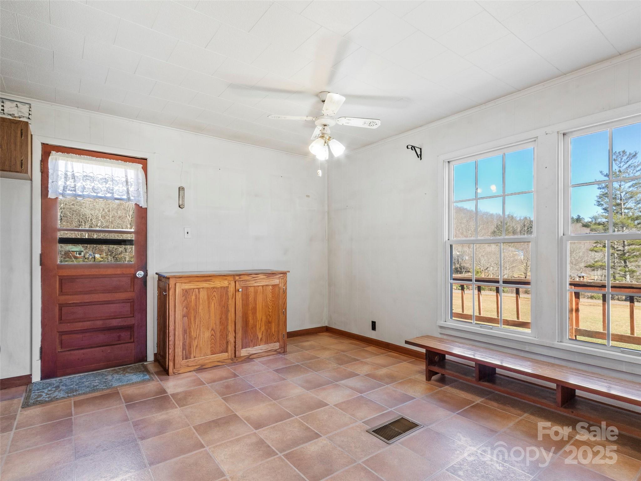 1879 White Oak Road Burnsville, NC 28714 - Photo 12 of 37 an empty room with windows and cabinet