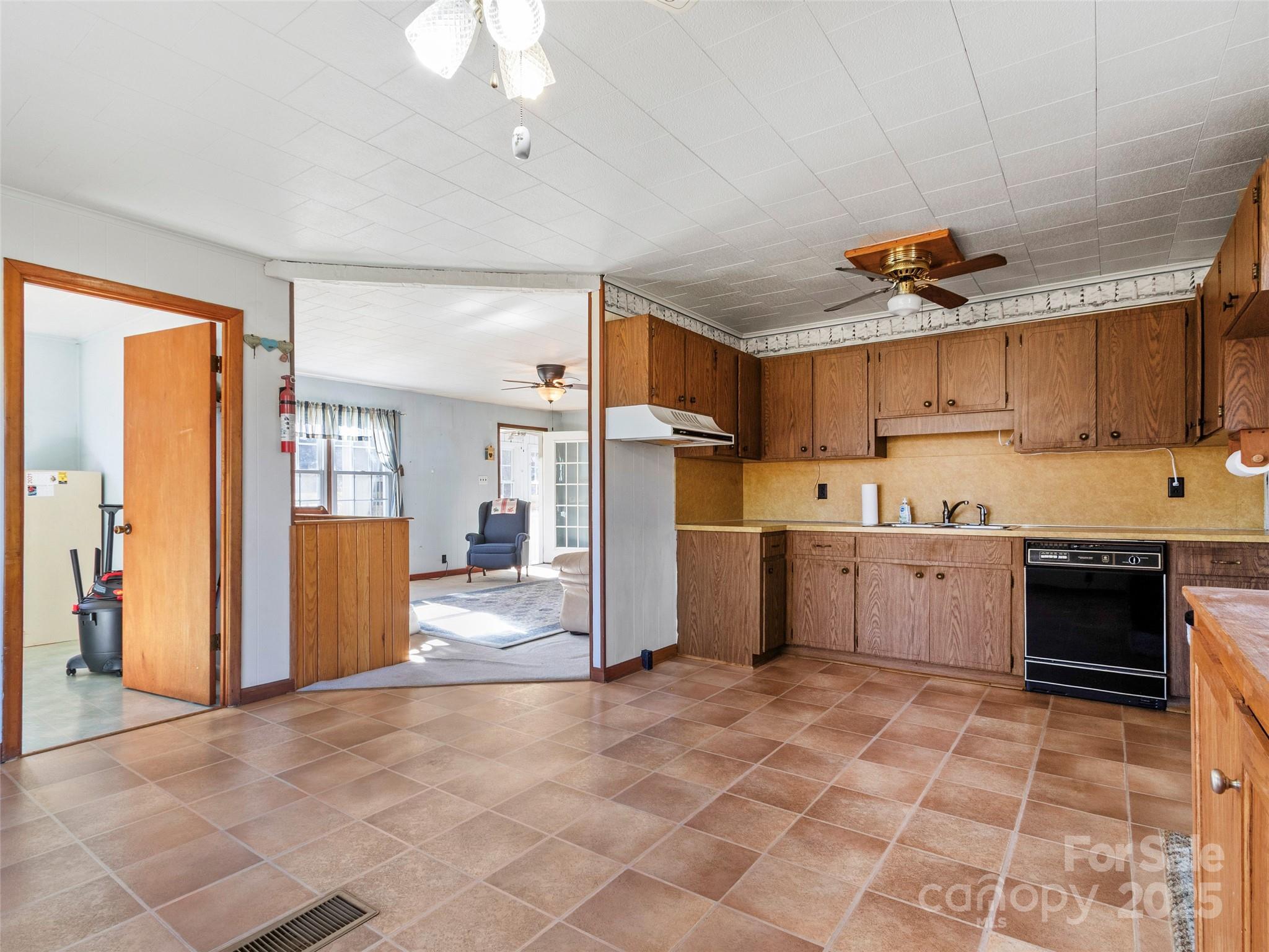 1879 White Oak Road Burnsville, NC 28714 - Photo 14 of 37 a kitchen with a refrigerator a sink and cabinets
