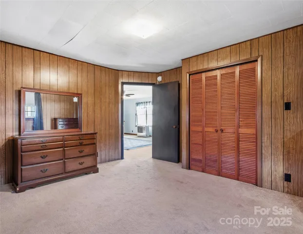 a bedroom with a bed and a cabinet