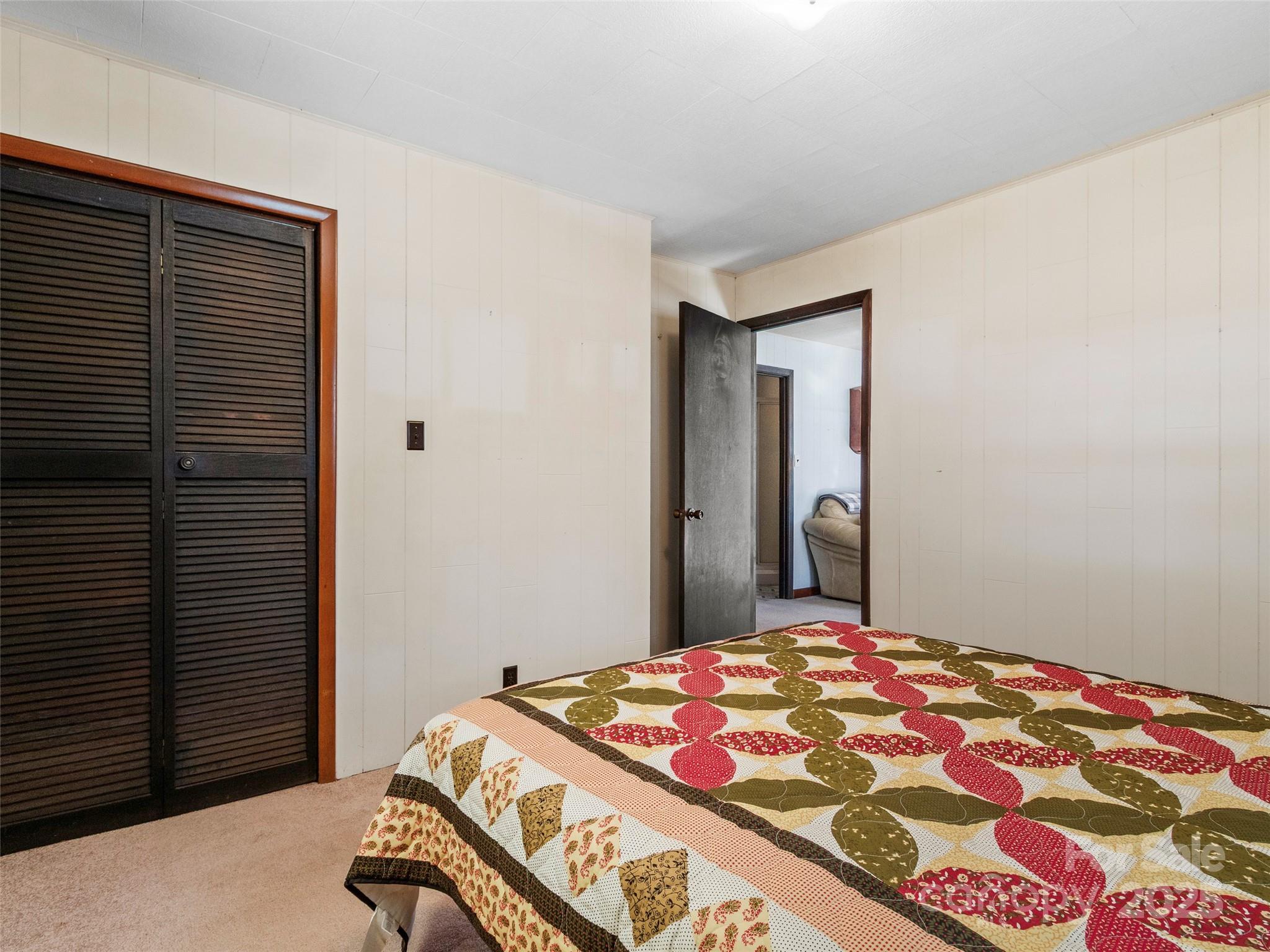 1879 White Oak Road Burnsville, NC 28714 - Photo 22 of 37 a bedroom with a bed and a cabinet