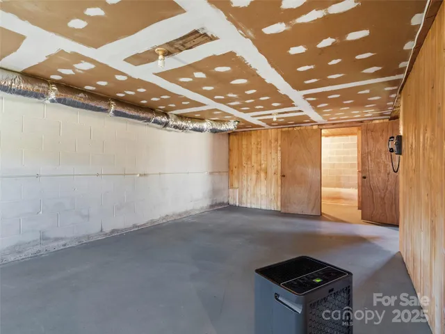 a view of a hallway with wooden walls