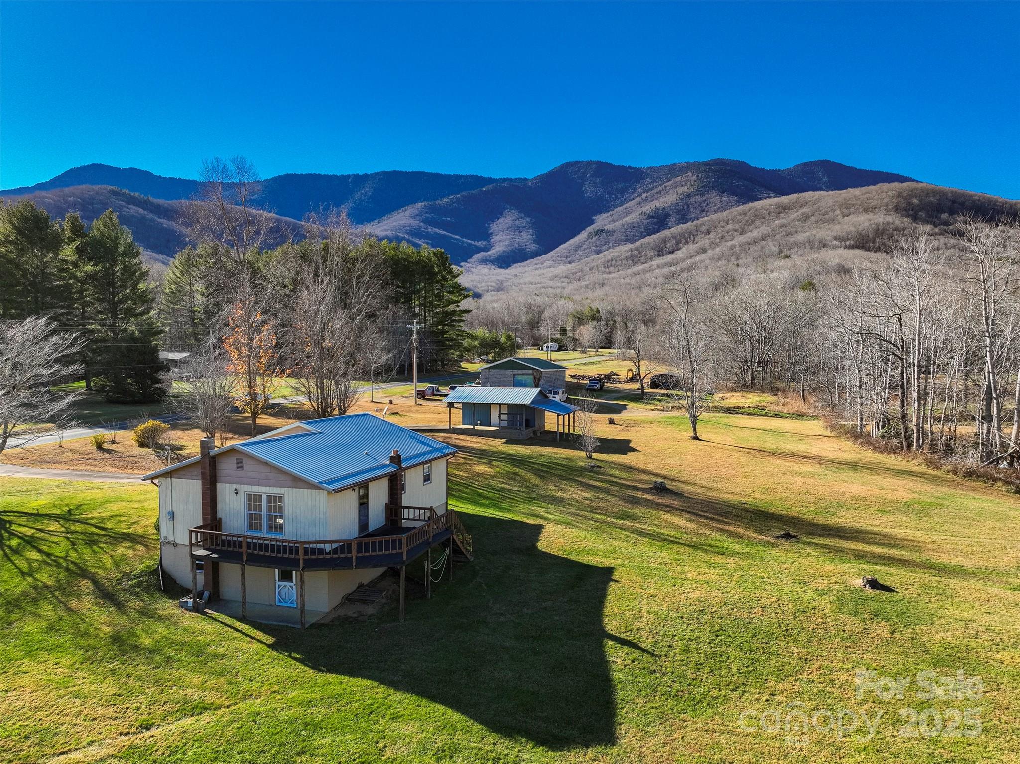 1879 White Oak Road Burnsville, NC 28714 - Photo 3 of 37 a view of a swimming pool with a table under an umbrella