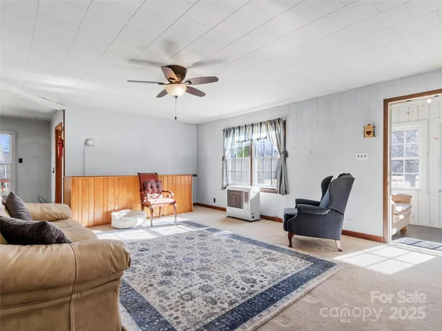 a living room with furniture rug and window