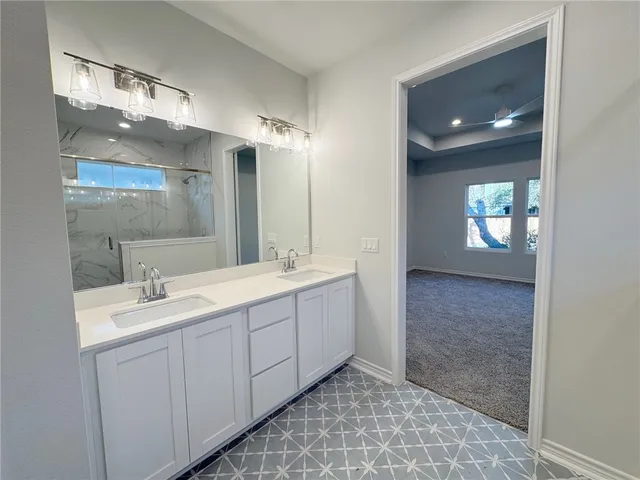a bathroom with a sink a vanity and mirror