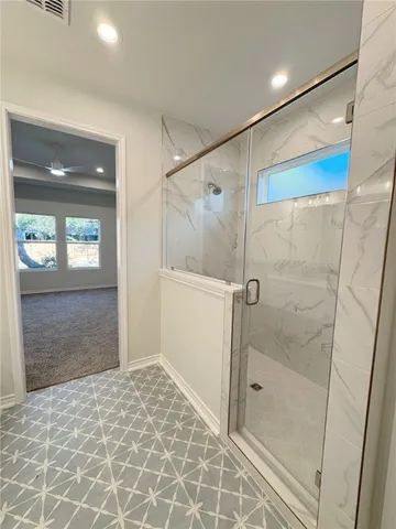 a bathroom with a shower and a sink