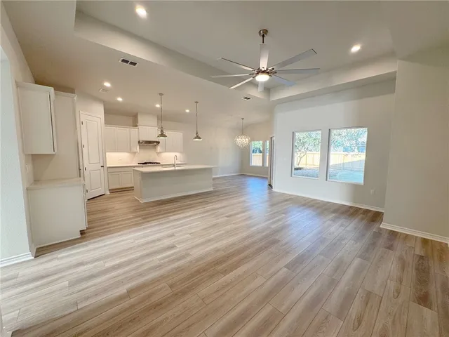 a view of kitchen and kitchen with windows