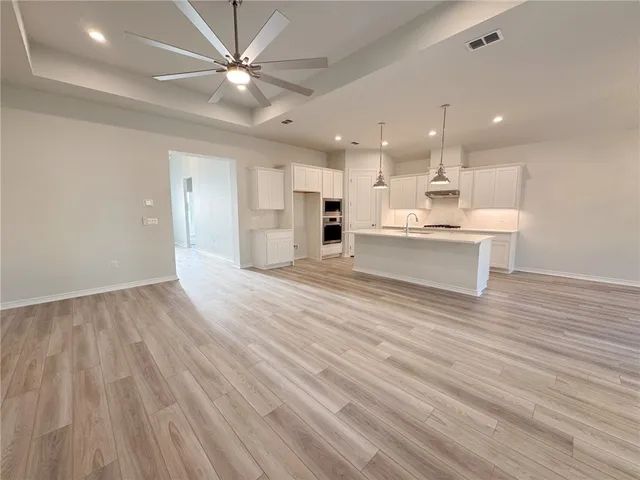 a view of kitchen with cabinets and wooden floor