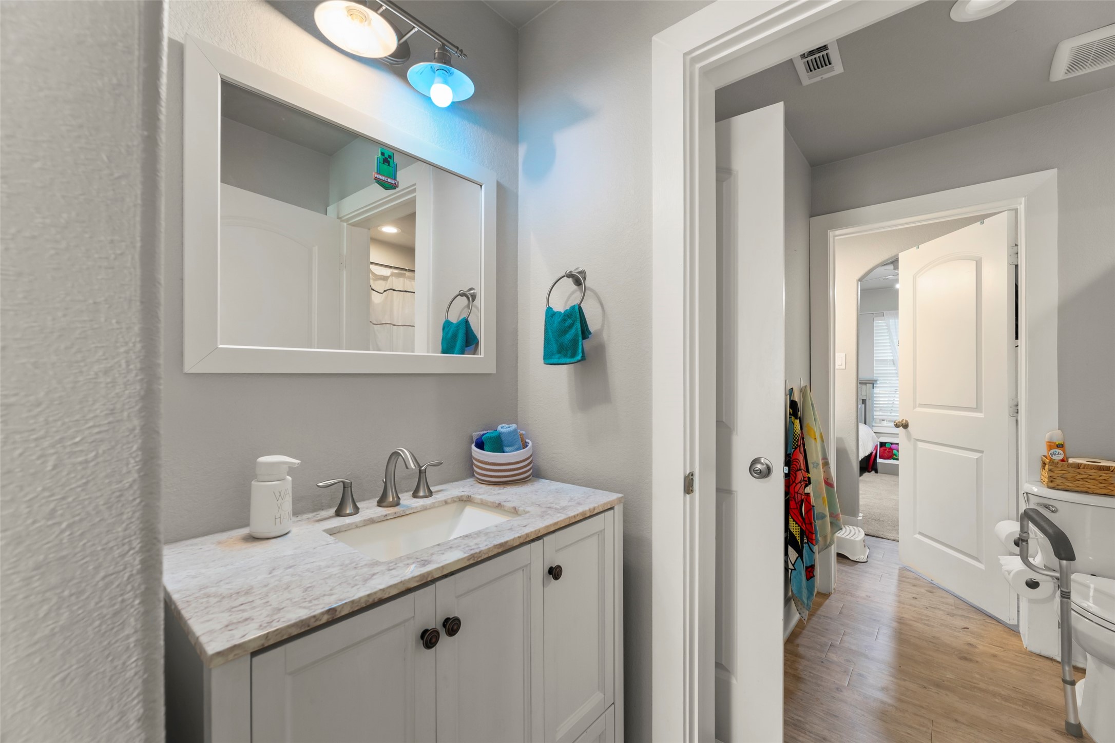 23918 Overcup Drive Spring, TX 77389 - Photo 17 of 37 a en suite bathroom with a granite countertop sink and a mirror