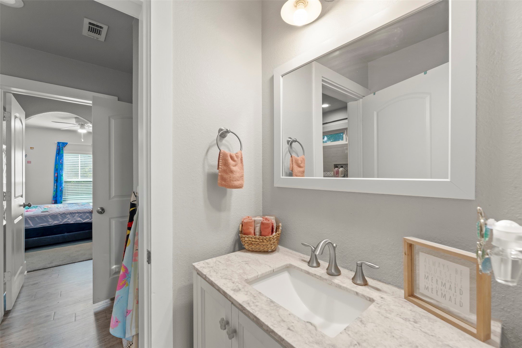 23918 Overcup Drive Spring, TX 77389 - Photo 22 of 37 a en suite bathroom with a granite countertop sink and a mirror