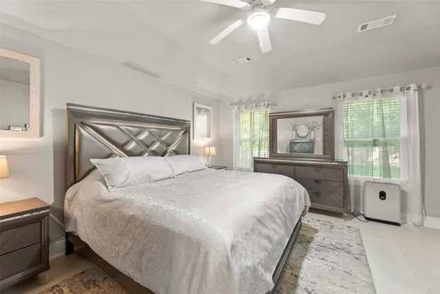 a bedroom with a large bed and a window