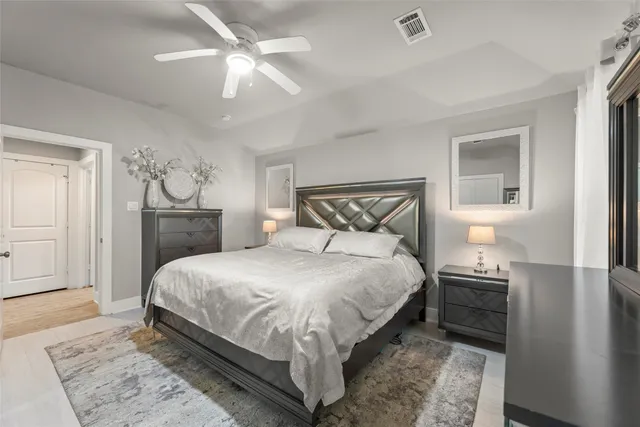 a bedroom with a bed and a lamp