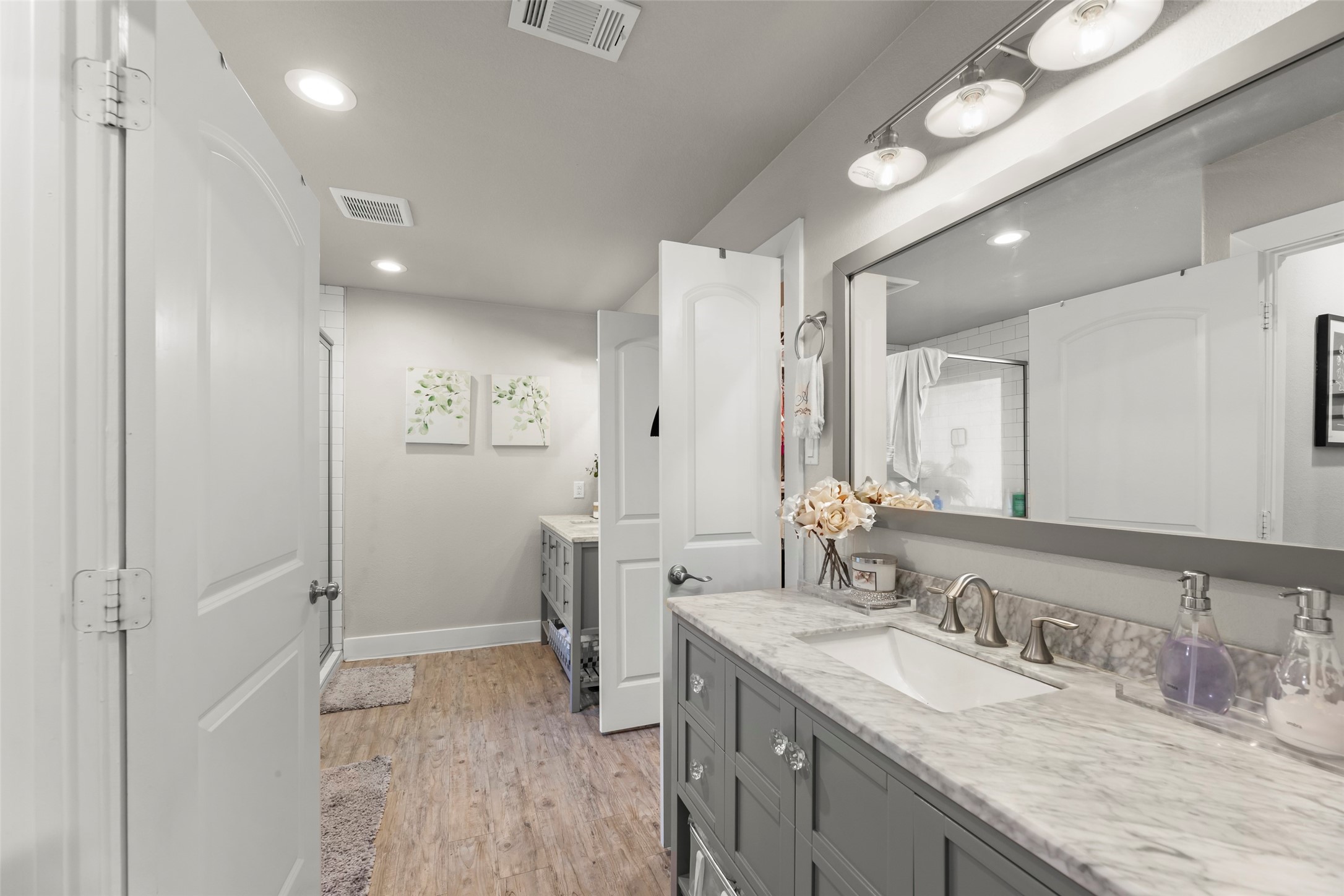 23918 Overcup Drive Spring, TX 77389 - Photo 25 of 37 a spacious bathroom with a granite countertop sink a mirror and a shower