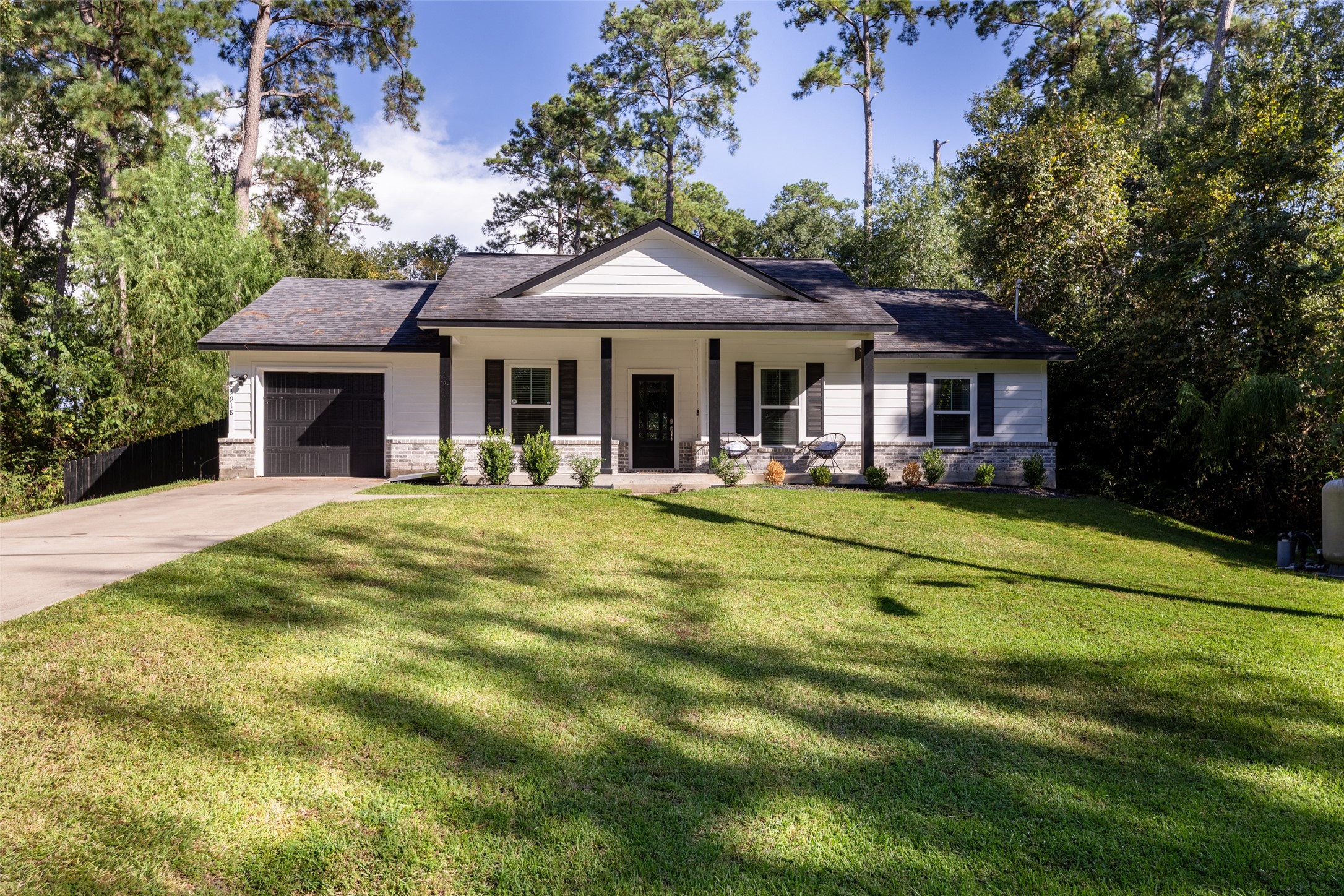 23918 Overcup Drive Spring, TX 77389 - Photo 3 of 37 a front view of a house with swimming pool and porch