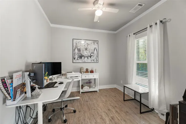 a view of a workspace with furniture and a window