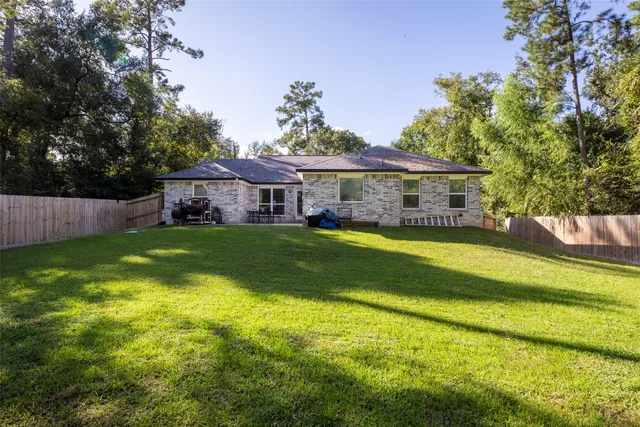 a view of house with garden space and sitting area