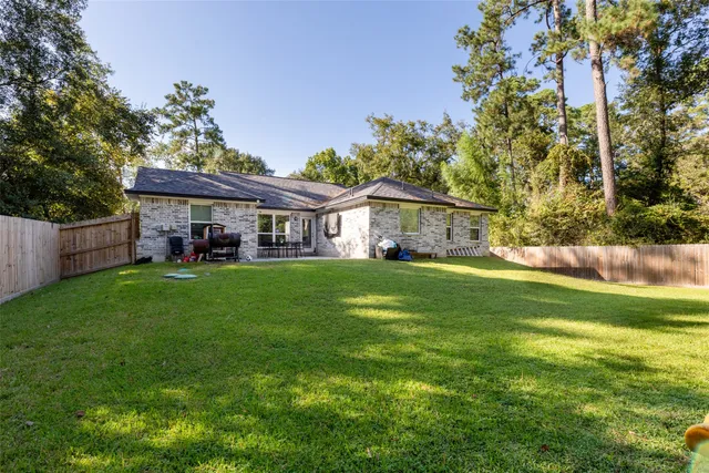a view of house that has a yard