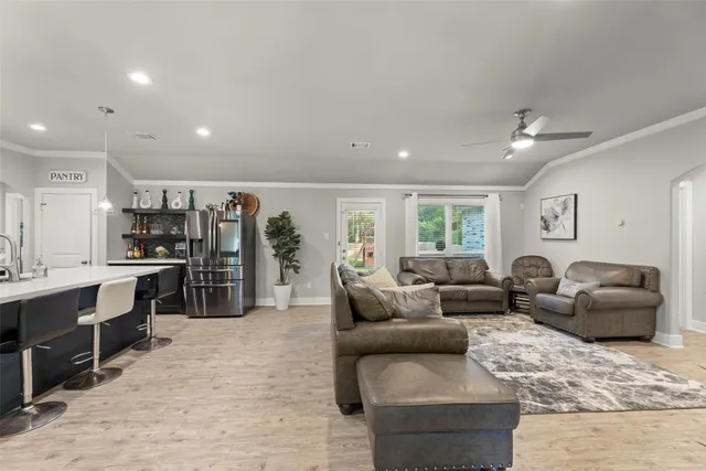 a living room with furniture and kitchen view