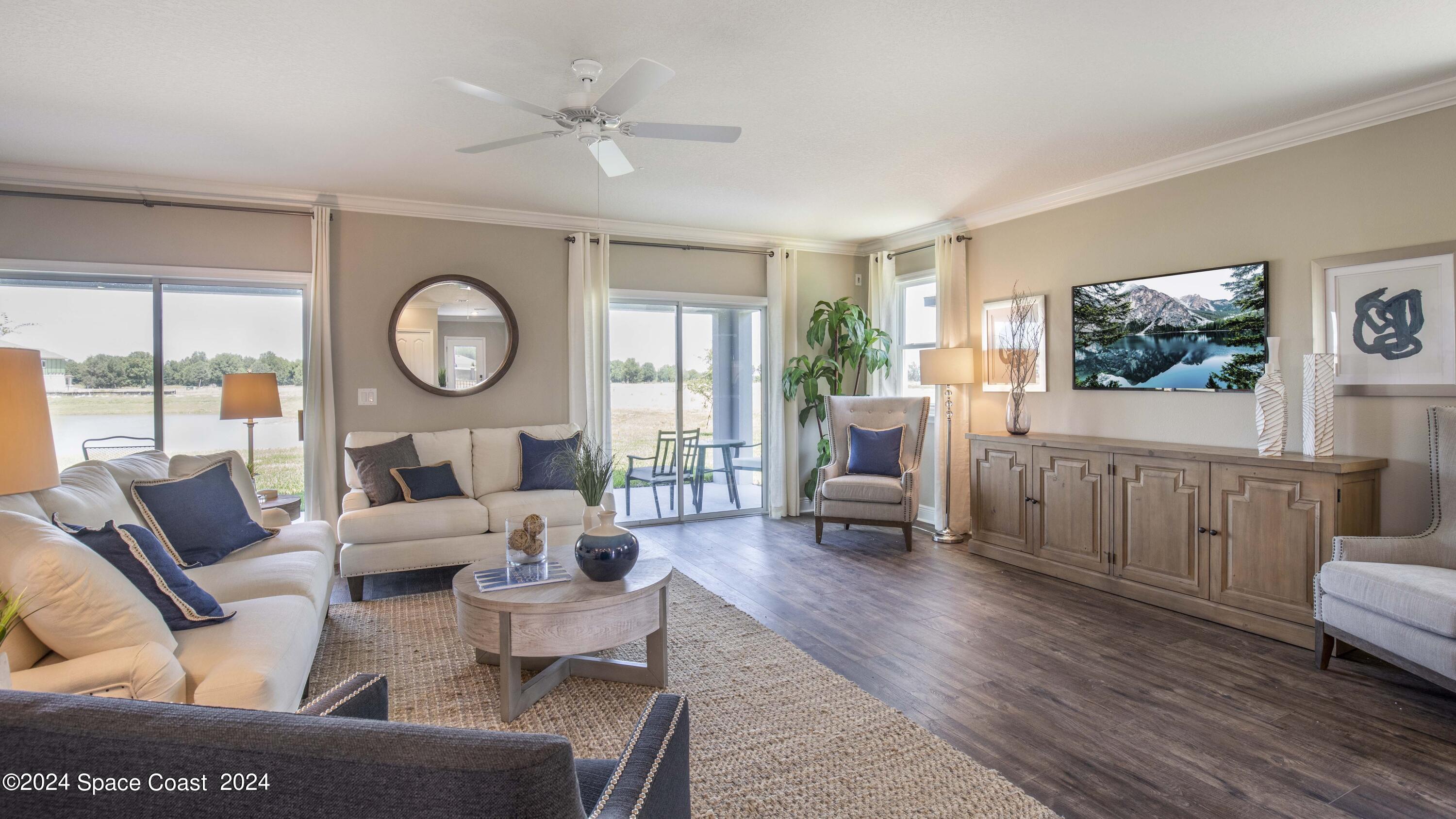 1448 Cygnus Place Merritt Island, FL 32953 - Photo 6 of 34 a living room with furniture a large window with wooden floor