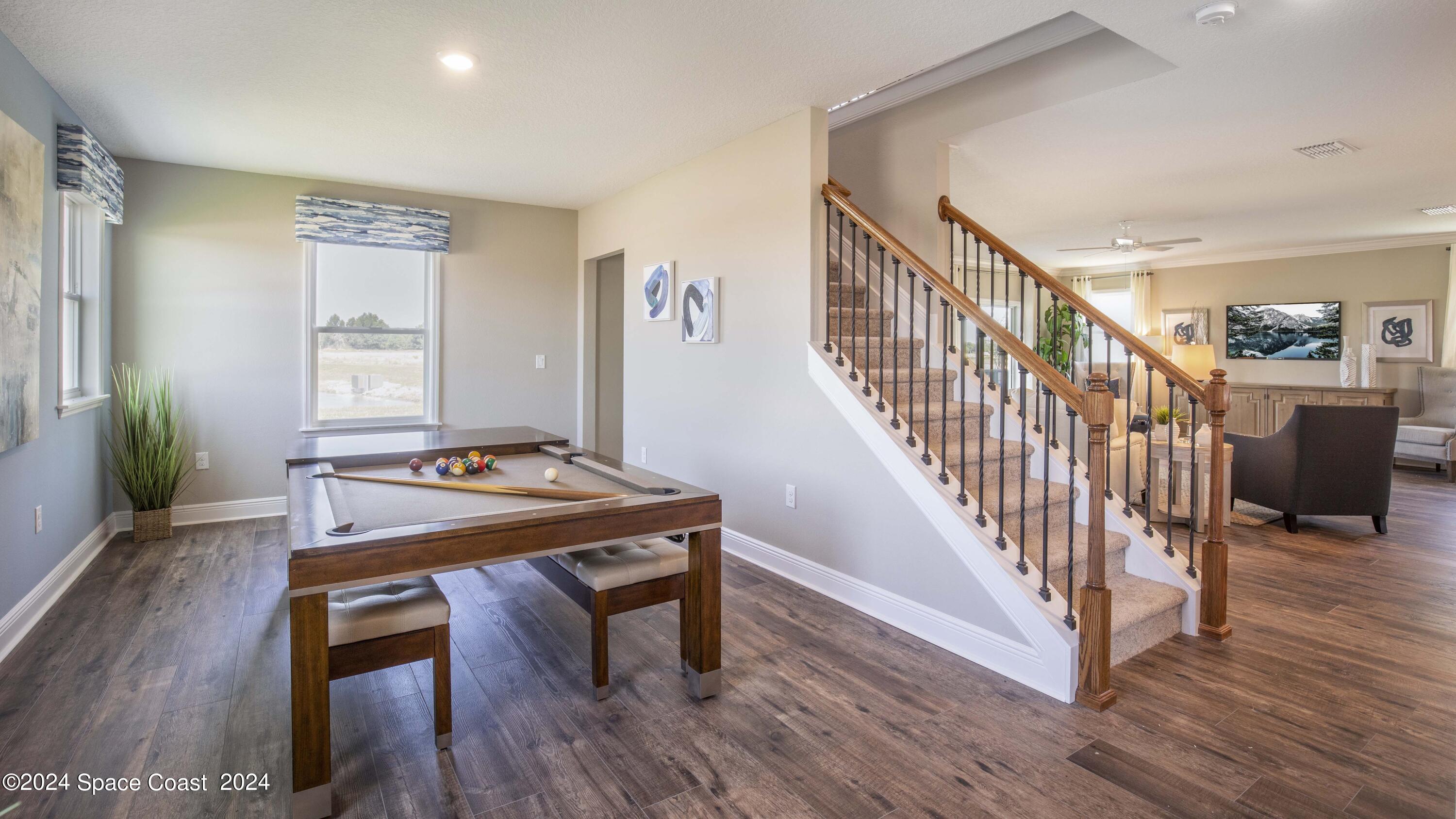 1448 Cygnus Place Merritt Island, FL 32953 - Photo 9 of 34 a view of a workspace with furniture and wooden floor