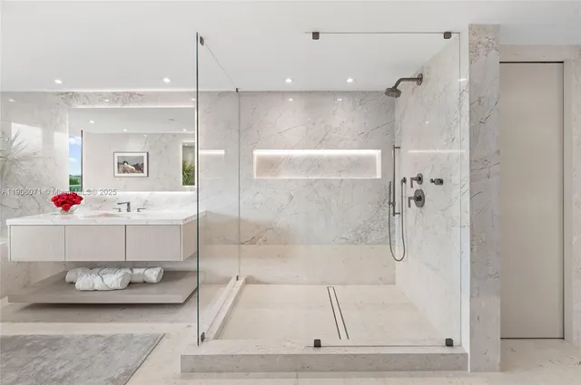 a bathroom with a tub shower and sink